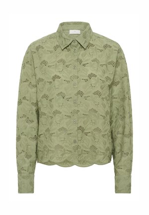 Chemise à manches longues vert clair avec broderie florale, fermeture à boutons et ourlet festonné. Tissu doux avec une finition texturée, présentant des motifs décoratifs.