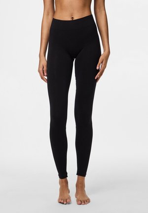 Black leggings with a high waistband, featuring a smooth texture and form-fitting design, extending to the ankles with a full-length cut.