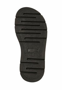 Black rubber shoe sole featuring deep ridges and a reinforced heel. Stamped branding and size 37 visible on the surface.