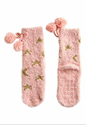 Fuzzy pink socks with gold star and moon patterns, featuring pink pom-poms, and textured grip soles for added traction.