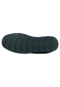 Sole di sneaker nera con motivo testurizzato a onde; presenta scanalature e accenti sollevati per una maggiore trazione. Materiale in gomma.