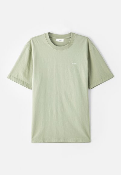 Tricou din bumbac de culoare verde deschis, cu mâneci scurte, guler rotund și un logo mic alb pe piept. Textură moale, croială lejeră și design minimal.