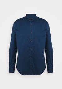 Camisa azul marino abotonada con cuello, mangas largas y dobladillo curvo. Confeccionada con una tela lisa que presenta botones marrones como detalles.