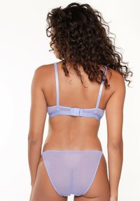 Light lavender bra and matching thong, smooth fabric, adjustable straps, and a hook-and-eye closure at the back. Minimalist design.