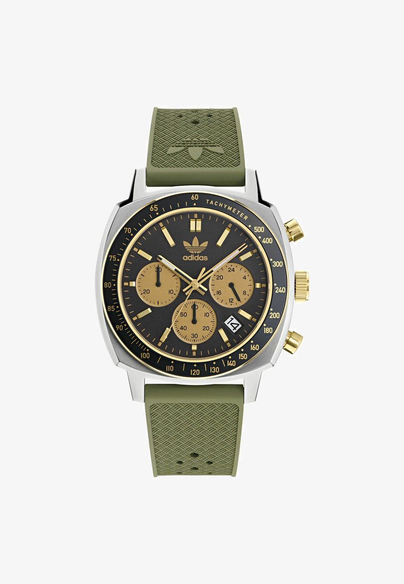 Kronogrāfa pulksteņi ar melnu ciparnīcu, zelta akcentiem, sudraba nerūsējošā tērauda korpusu un zaļu gumijas siksniņu ar teksturētu rakstu.