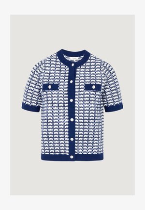 Cardigan a maniche corte in maglia blu navy e bianca, caratterizzato da un motivo a rilievo, due tasche frontali e grandi bottoni bianchi.