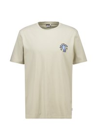 Camiseta de algodón color beige con mangas cortas y escote redondo. Presenta una figura bordada en azul en el lado izquierdo del pecho.