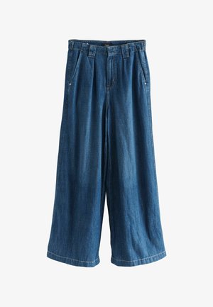 Pantalons en denim à jambe large de couleur bleu foncé. Présentent une devant plissé, deux poches latérales et une finition texturée. Ourlet propre aux poignets.