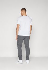 Champion ICONS CUFF PANTS LARGE LOGO - Pantalones deportivos - dark grey