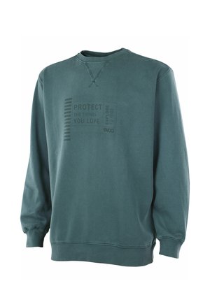 Dark green crewneck sweatshirt with ribbed cuffs and hem, featuring faint text "Protect the things you love" and subtle graphic on front.