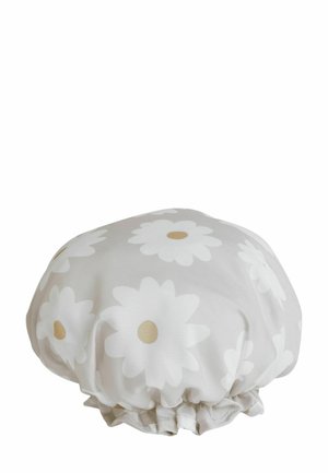 Soft fabric shower cap with elastic edge, decorated with large white daisy flowers with beige centers on a light background.