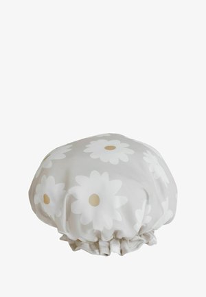 Soft fabric shower cap with elastic edge, decorated with large white daisy flowers with beige centers on a light background.