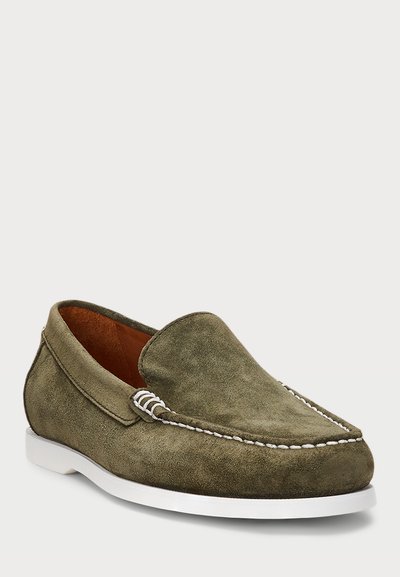 Olive green suede loafers with white stitching, closed toe, flexible sole, and a smooth texture. Minimalist design, slip-on style.