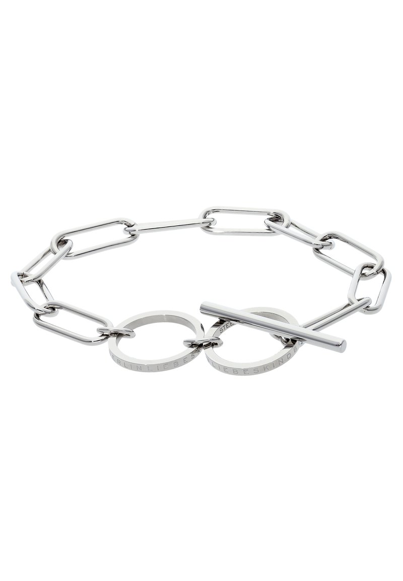 Silver chain link bracelet featuring elongated links, circular accents, and a toggle closure, with engraved detailing on the rings.