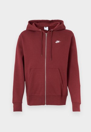 Sudadera con cremallera color burdeos fabricada en tejido de sudadera, con capucha ajustable, bolsillos frontales y un logo de Nike blanco en la parte superior izquierda del pecho.