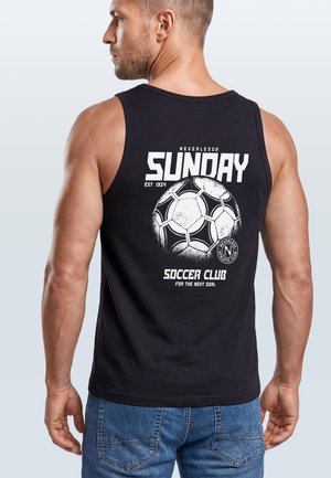 Man seen from behind wearing a black sleeveless shirt with a white soccer ball and "Sunday Soccer Club" text printed on the back.