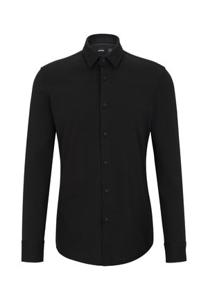 Chemise noire à manches longues en tissu texturé, avec un devant boutonné, un col pointu et un ourlet arrondi.