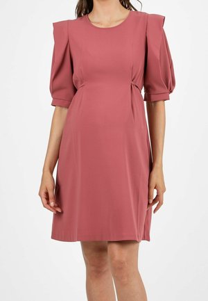 Woman wearing a dusty rose pink knee-length dress with puffed elbow-length sleeves and cinched waist details.