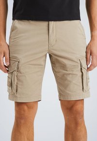 Beige cargo shorts with multiple side pockets, stitched detailing, and a relaxed fit. Made from lightweight cotton.