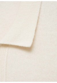 Beige knit sweater fabric with a ribbed texture. Features a flat collar and soft finish. Close-up view highlights material details.