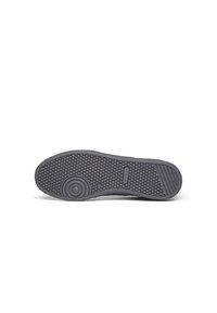 Sole of a dark gray casual shoe with circular pattern near the toe and honeycomb texture covering the bottom surface.