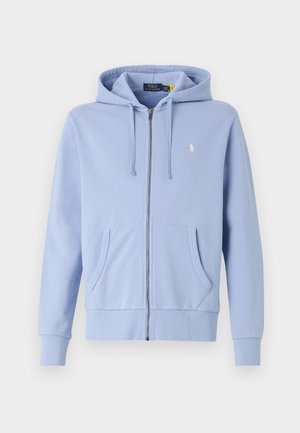 Felpa con zip azzurro chiaro realizzata in morbido cotone, dotata di tasca a marsupio, polsini a coste e un piccolo logo ricamato sul petto.