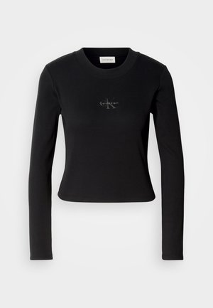 Top negro de manga larga con un diseño ajustado y un pequeño logo de Calvin Klein en el pecho, presentado sobre un fondo blanco.