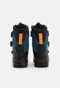 Waterproof hiking boots with black rubber soles, blue and black textile upper, orange accents, and adjustable straps. Reinforced heel for support.
