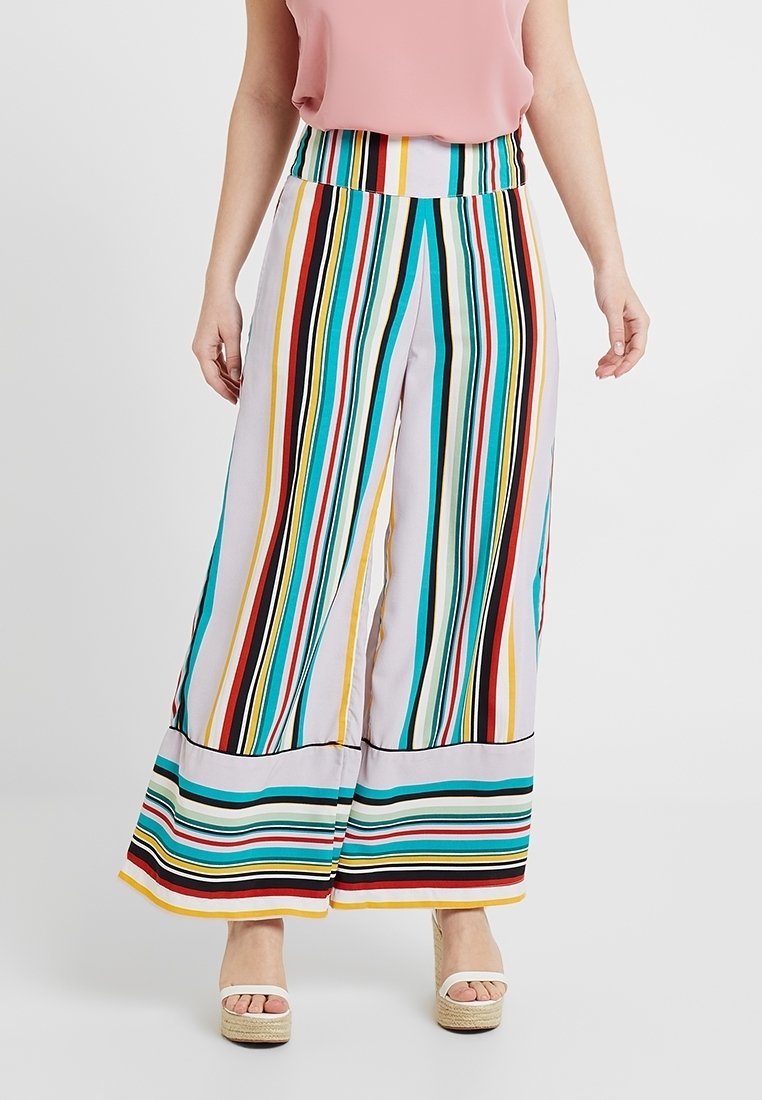 Wide-leg striped pants in lightweight fabric featuring multicolored stripes. The waistband is elastic, and the pants have a loose fit.