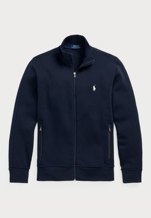 Navy zip-up sweatshirt made of soft fabric, featuring a high collar, two side pockets with zippers, and a white polo logo on the chest.
