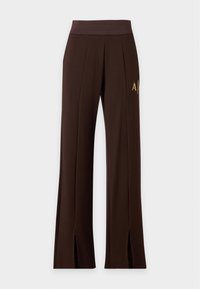 Pantalon large marron foncé avec taille élastique, coutures sur l'avant, logo sur le côté et fentes à l'avant de l'ourlet.