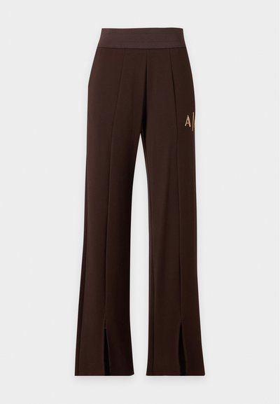 Pantalon large marron foncé avec taille élastique, coutures sur l'avant, logo sur le côté et fentes à l'avant de l'ourlet.