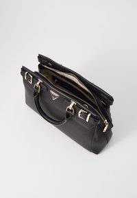 Black leather handbag with gold-tone hardware, dual top handles, and zipper closure. Features a textured surface and an inner compartment.