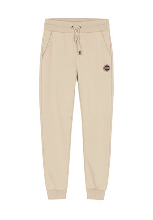 Pantaloni della tuta beige realizzati in morbido tessuto, con vita elasticizzata e cordoncino, tasche laterali e un'etichetta rotonda con logo.