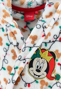 Accappatoio bianco peluche con motivi di pan di zenzero marroni e luci colorate. Presenta un design ricamato di Minnie Mouse con accenti dorati sulla parte anteriore.