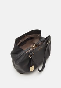 Borsa a mano in pelle nera con forma arrotondata, dettagli in metallo dorato e interno di un marrone chiaro. Presenta un logo, chiusura con zip e tracolla regolabile.