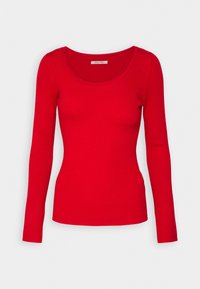 Rotes, geripptes Langarmshirt mit Rundhalsausschnitt. Glatte Textur und figurbetonte Passform, geeignet für legere Lagenlooks oder zum Alleintragen.