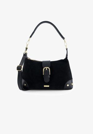 Black suede handbag with a structured shape, featuring a leather strap, gold buckle accent, and studded detail on the base. Zipper closure.