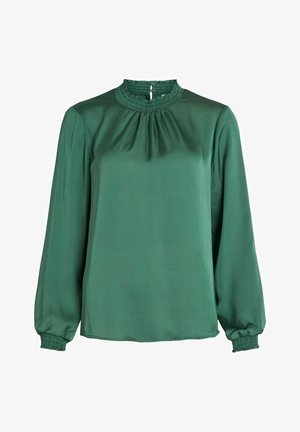 Blouse vert foncé à manches longues avec un col montant froncé et des poignets smockés sur les manches, fabriquée en tissu lisse.