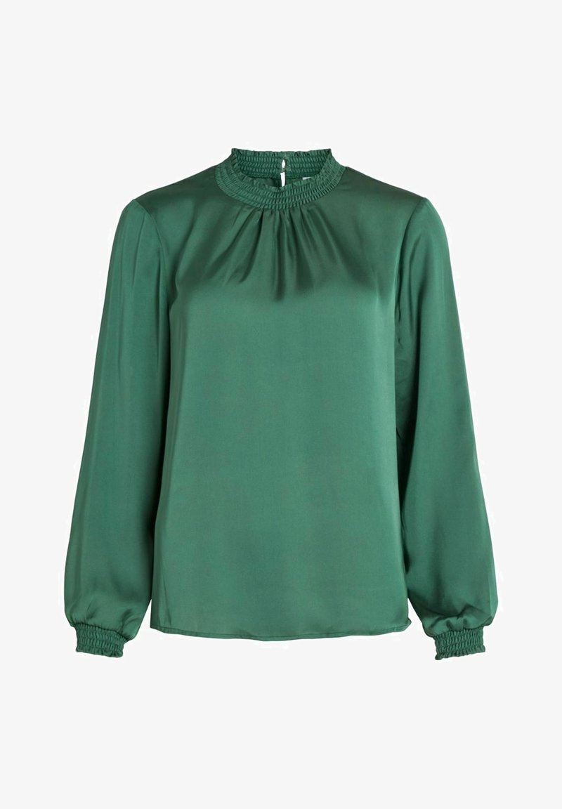 Blouse vert foncé à manches longues avec un col montant froncé et des poignets smockés sur les manches, fabriquée en tissu lisse.