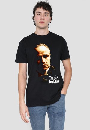 Black cotton t-shirt featuring a printed portrait and text of "The Godfather" in white. Short sleeves and a crew neckline.