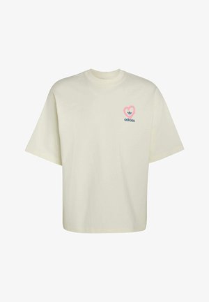Crèmewit T-shirt met korte mouwen en ronde hals, met een klein Adidas-logo in een roze hartje op de linkerborst.