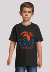 Black t-shirt featuring a Shiba Inu graphic in blue and orange, with Japanese text underneath, displayed on a child in casual jeans.