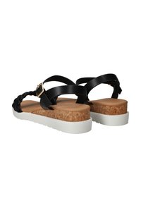 Sandales noires avec bride tressée, semelle intermédiaire en liège et semelle extérieure en caoutchouc blanc. Présente une boucle réglable et un talon plat pour le confort.