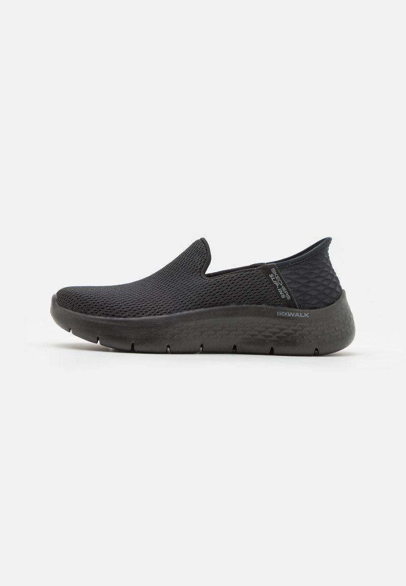 Black slip-on shoes with a textured mesh upper and a thick, cushioned sole featuring a diamond pattern for added grip and support.