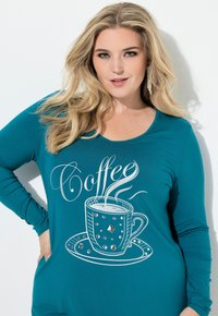 Turkusowa koszula z długim rękawem z grafiką filiżanki kawy ozdobioną srebrnymi akcentami i kryształkami, o okrągłym dekolcie i luźnym kroju.