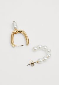 Gold hoop earring with a smooth finish, paired with a pearl drop earring featuring multiple glossy white pearls and gold hardware accents.