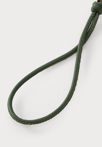 Green leather strap, thin, smooth texture, with a loop at one end and decorative stitching along the edge. Subtle sheen finish.