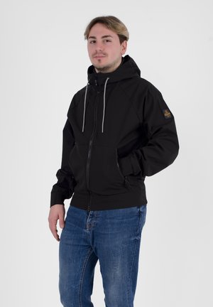 Giacca nera con zip e cappuccio, dotata di lacci grigi, tasche laterali e un'etichetta con logo sulla manica sinistra. Vestibilità casual, texture liscia.