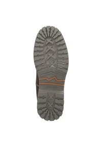 Semelle en caoutchouc grise avec un motif de texture pour l'adhérence, comportant un motif en zigzag et une ligne d'accent brune. Marque "Dockers" visible.